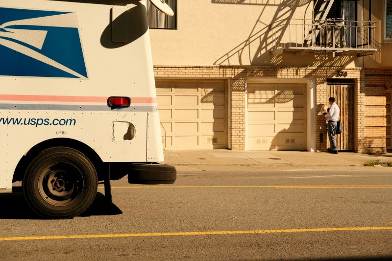 a mail truck parked on the side of a road