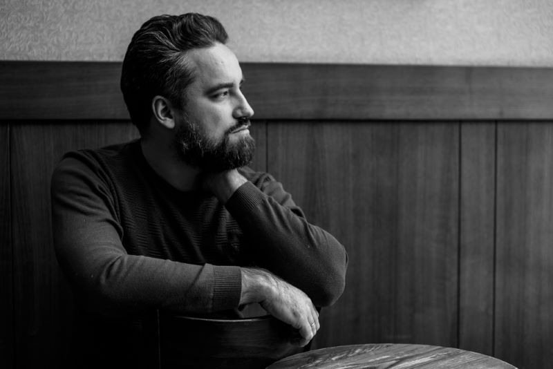 serious man sitting at table