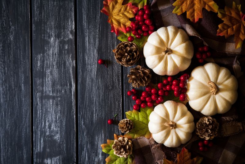 white pumpkins and fall decorations on a wooden table