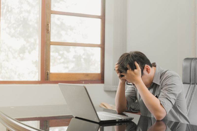 Stressed man sitting at his laptop