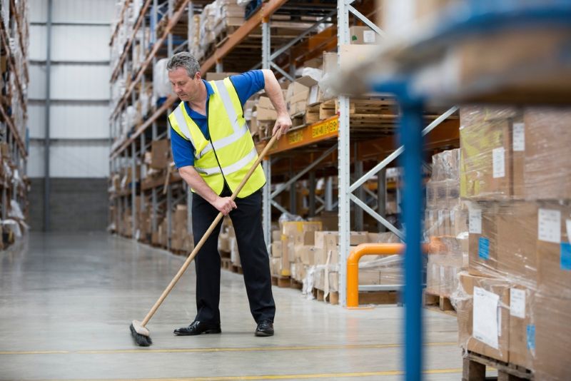 Worker mopping the floors in a warehouse