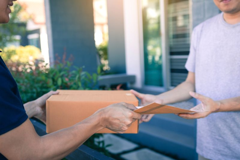 Postal worker delivering a package